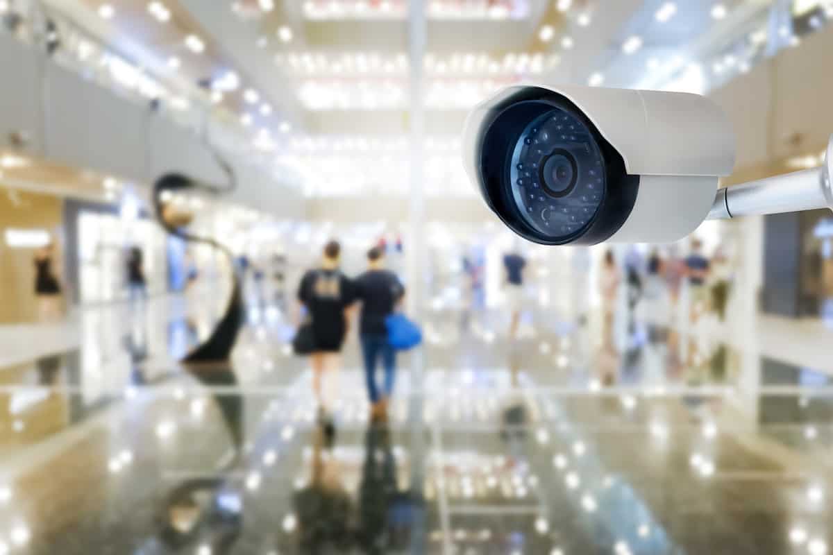 modern public cctv camera with blur interior shopping mall background copy space